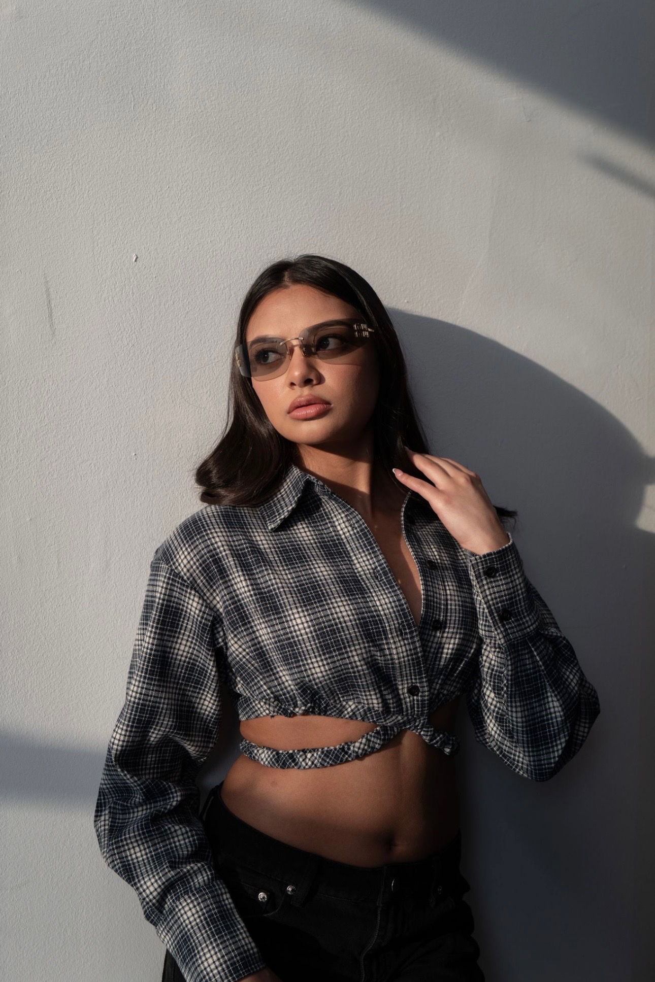 Customer in rimless tinted designer glasses and plaid shirt